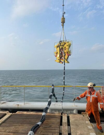 Deploying our underwater chop saw into the sea from a ship in the ocean