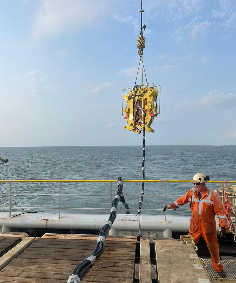 Deploying our underwater chop saw into the sea from a ship in the ocean